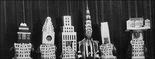 Illustration for article titled Crown or Dunce Cap? Starchitects Wear Their Famous Buildings As Hats